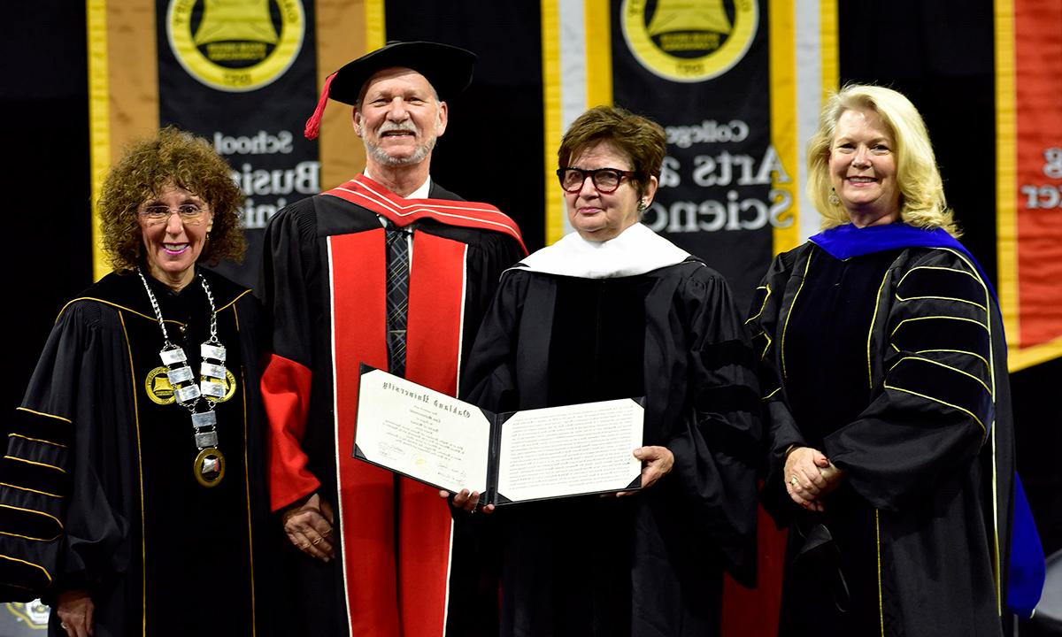A group of people holding a degree